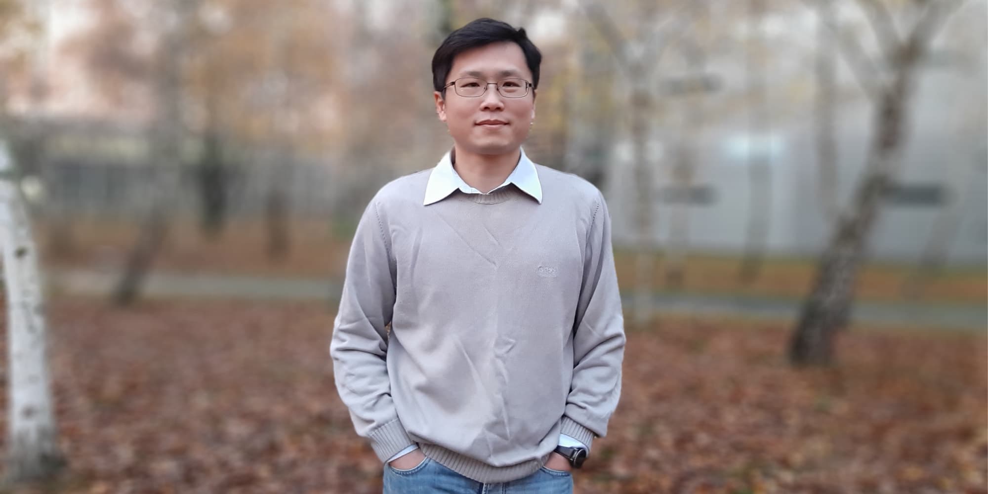PR-ERC Dr. Yao-Hong Liu standing outdoors in front of a blurred background