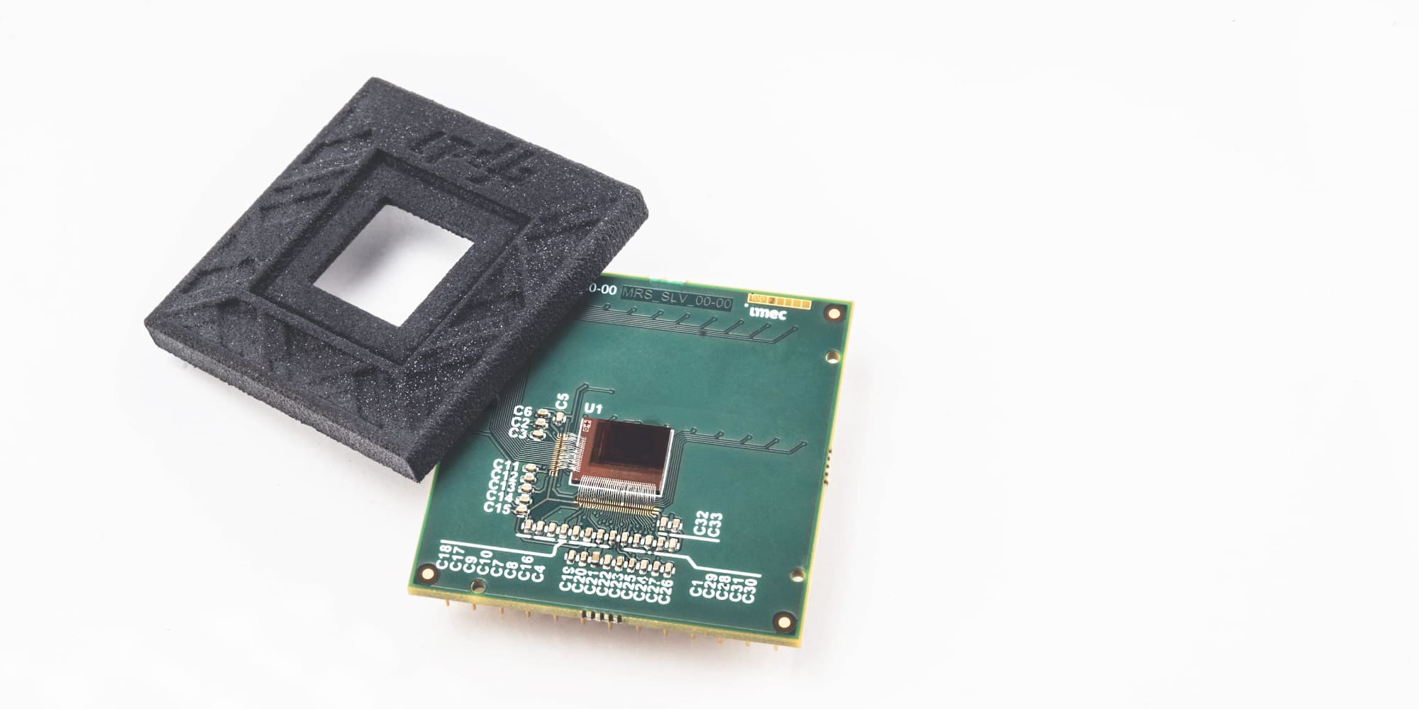 PR-TFPD Thin-film image sensor chip mounted on a green circuit board beside a black protective foam frame