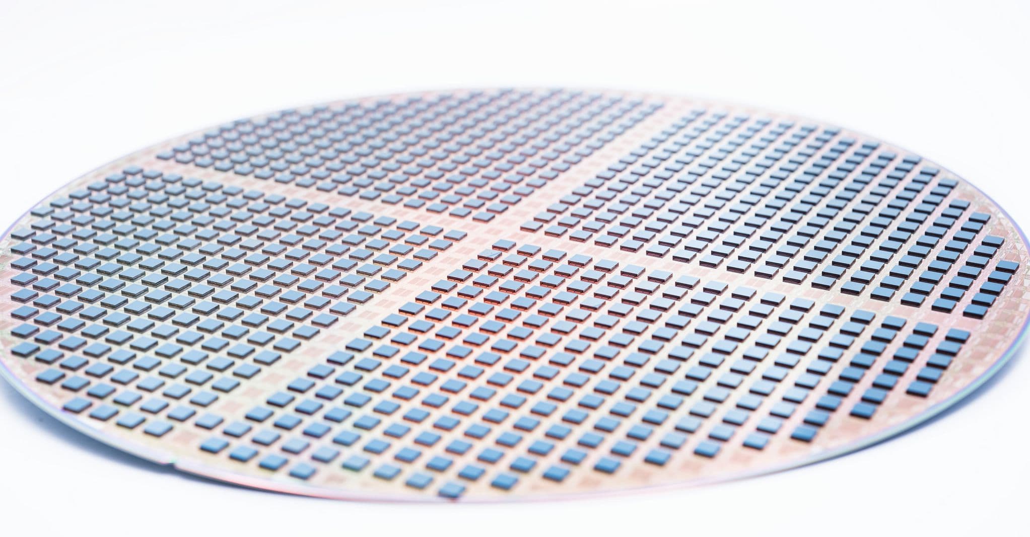 processed_wafer_with_a_second_layer_of_chips_stacked_on_top%2C_through_a_die-to-wafer_stacking_process_1 Silicon wafer covered with many small chips arranged in a grid, illustrating 3D chip stacking