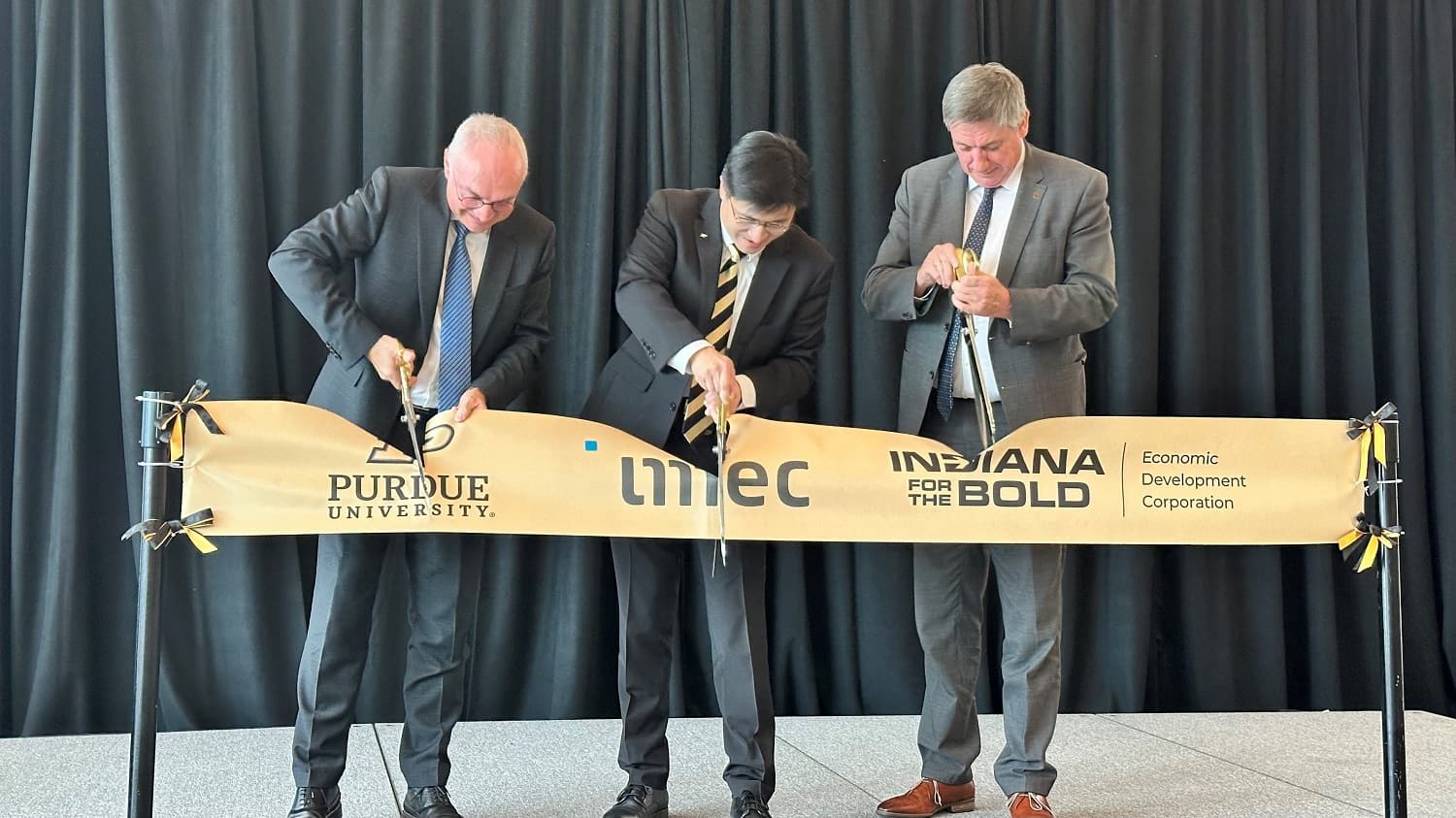 Purdue_4_header Three men in suits cut a ceremonial ribbon with Purdue University, imec, and Indiana logos.