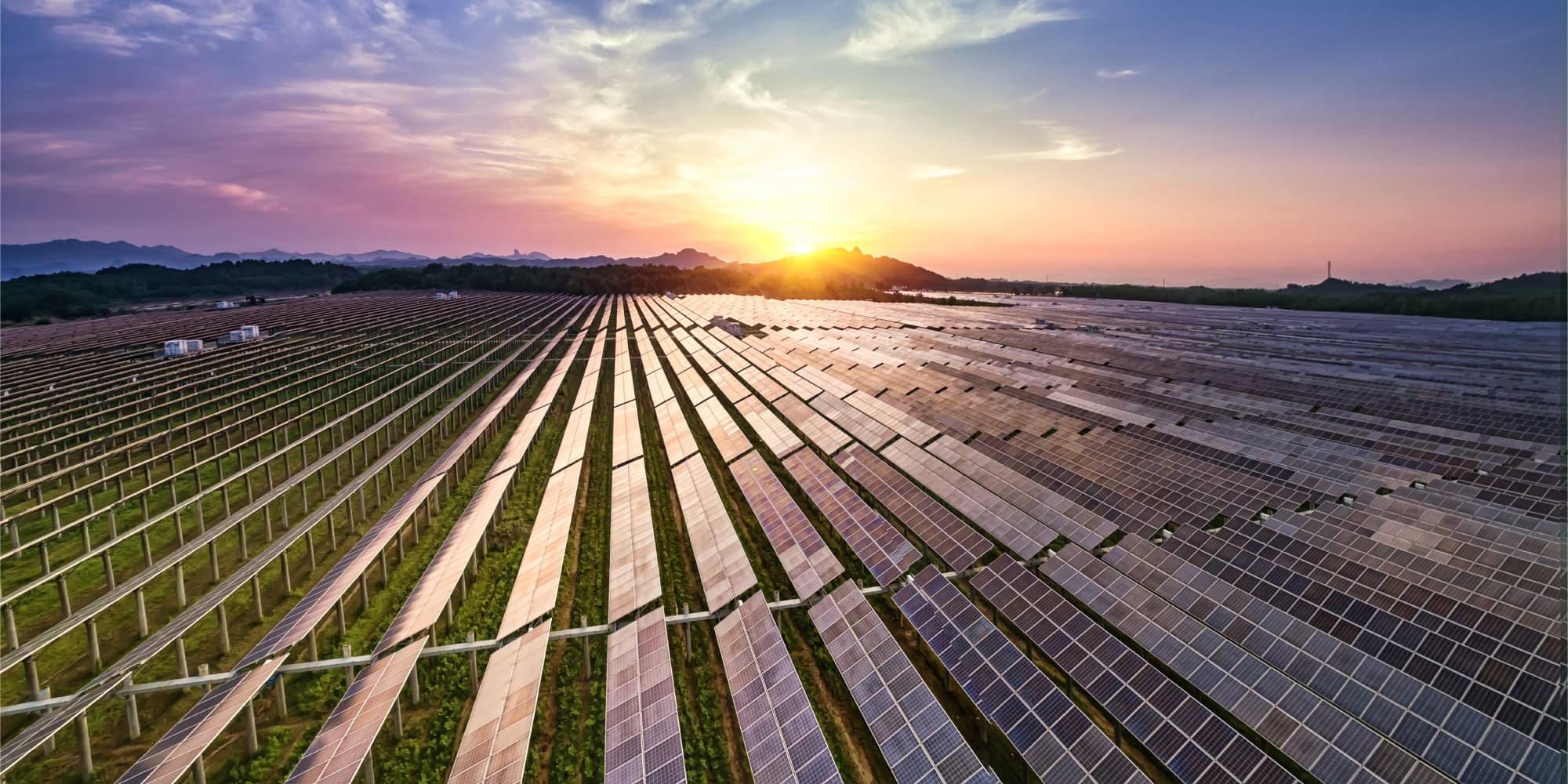 pvrecycling_1 Aerial view of a vast solar panel farm at sunset