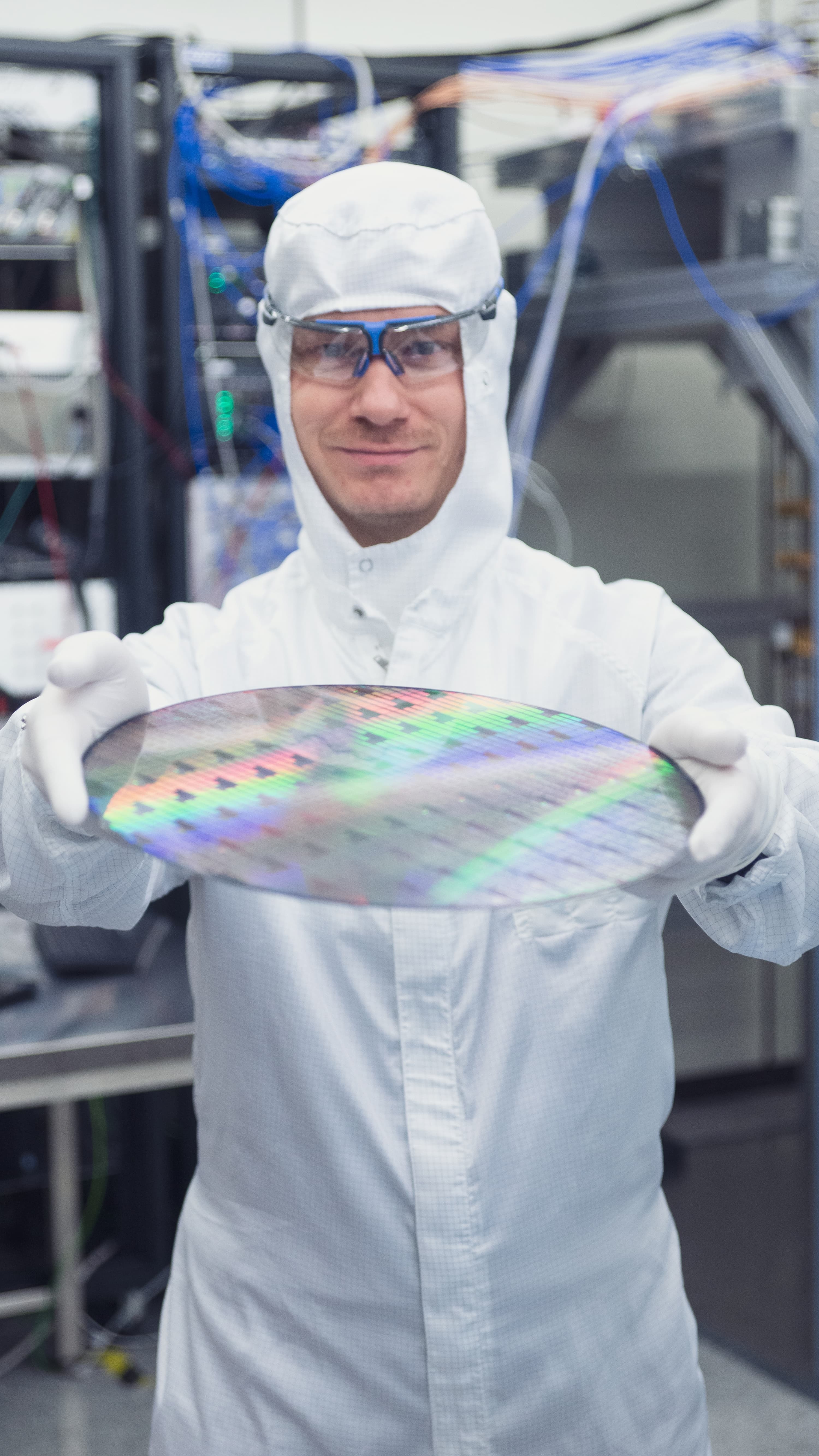 Quantum%20computing_1_0 Researcher in a cleanroom holding a large silicon wafer.