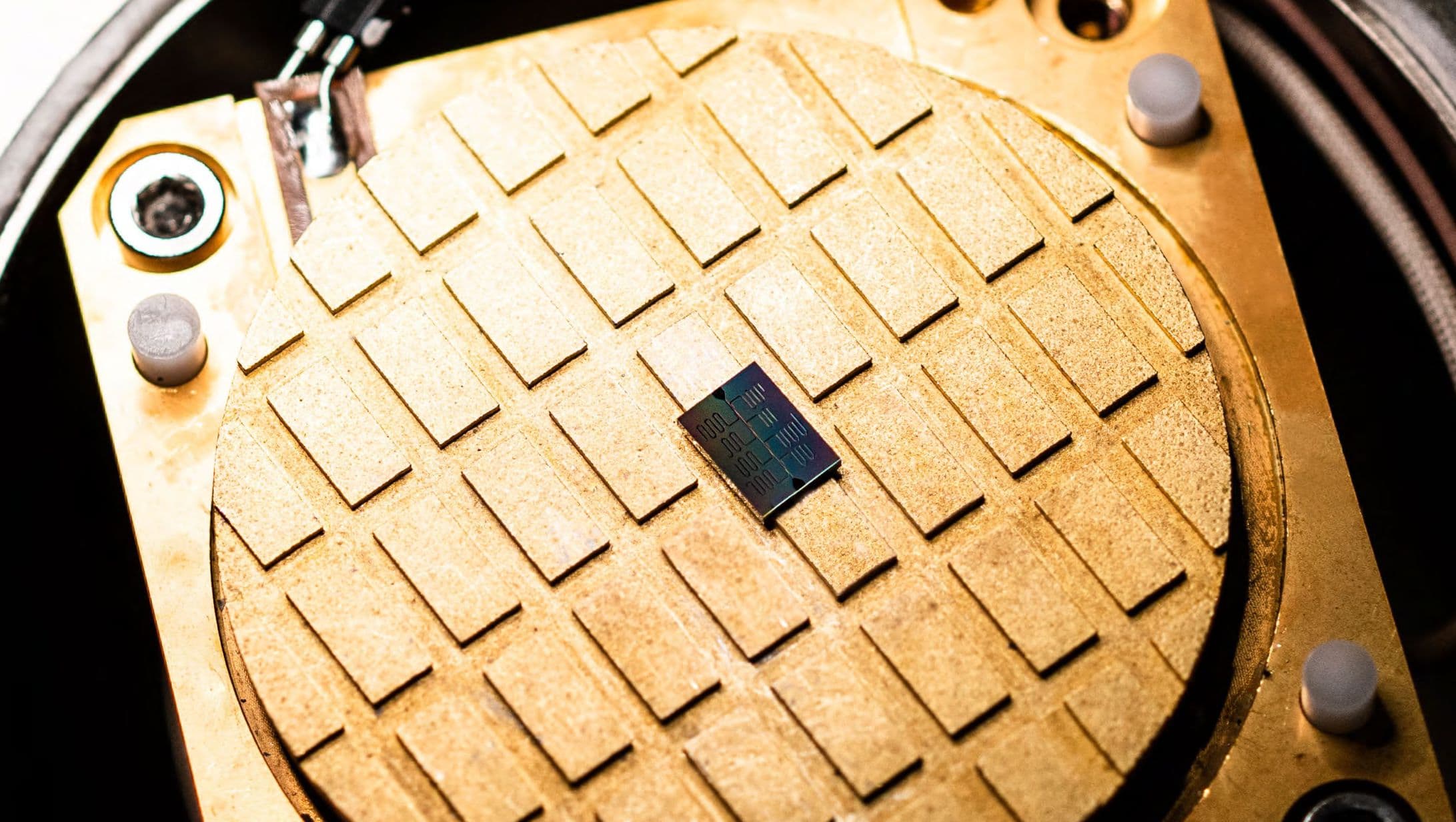 Quantum_computing_0 Quantum computing chip mounted on a circular test fixture