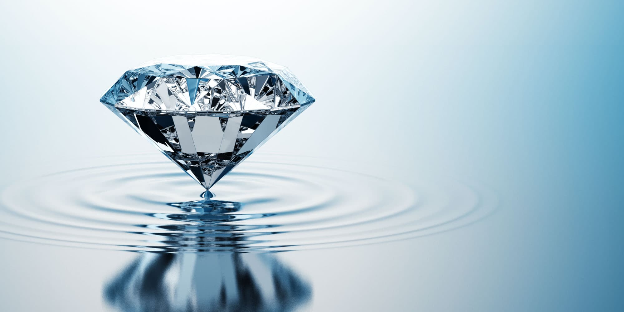quantum-header_0 Faceted diamond hovering above rippling water on a blue background