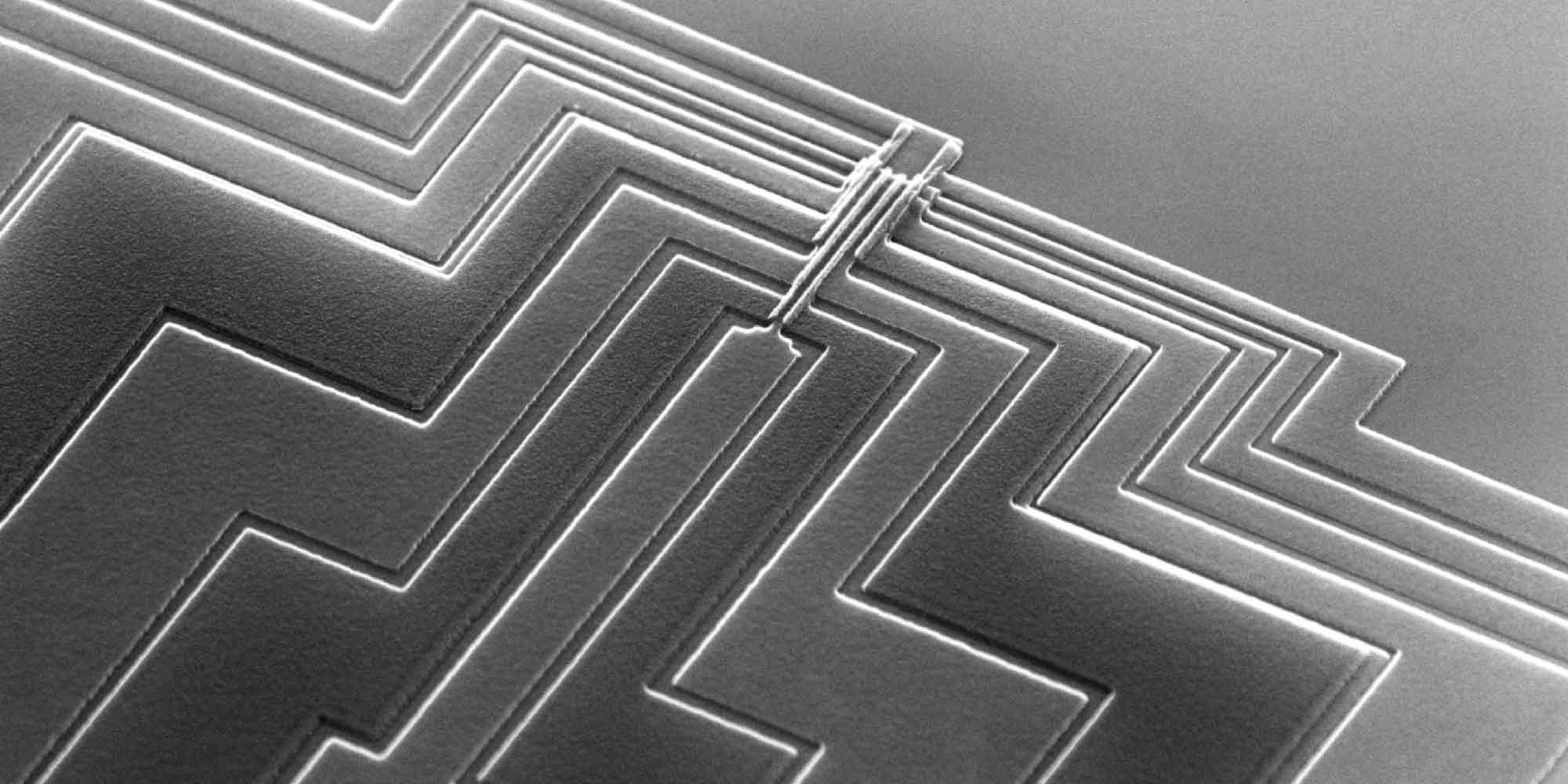 quantum-header Close-up of a microchip with layered circuit traces