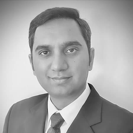 ravi-bw Headshot of Ravi Saxena in a suit and tie