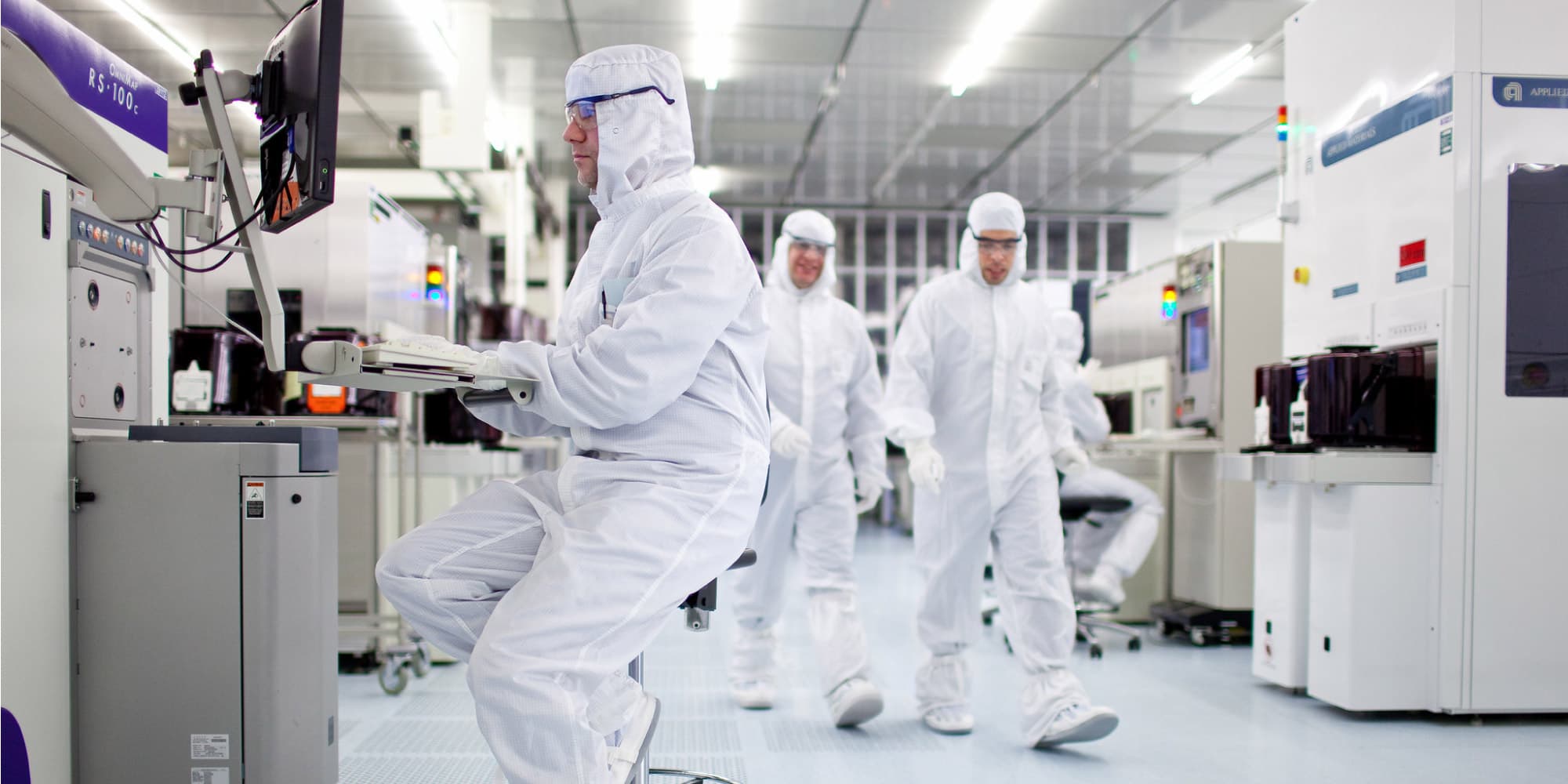 Research Researchers in a cleanroom operating semiconductor equipment