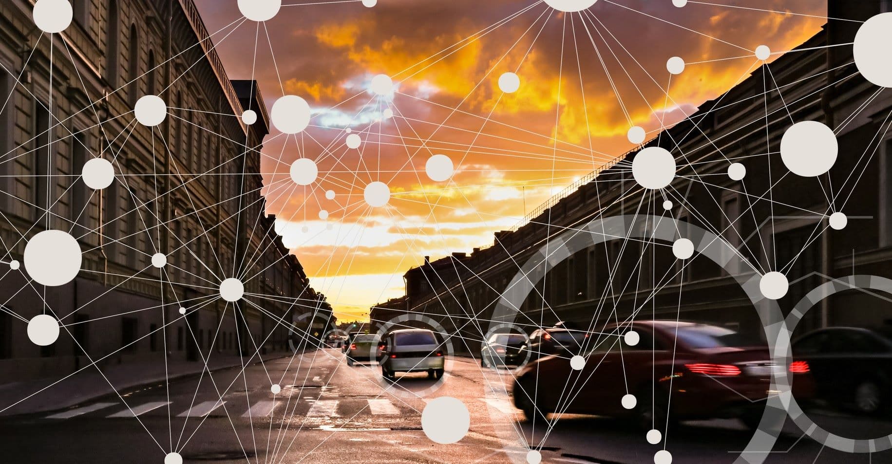 SENSAI%20header Cars driving through a city street at sunset with an overlaid sensor-network graphic
