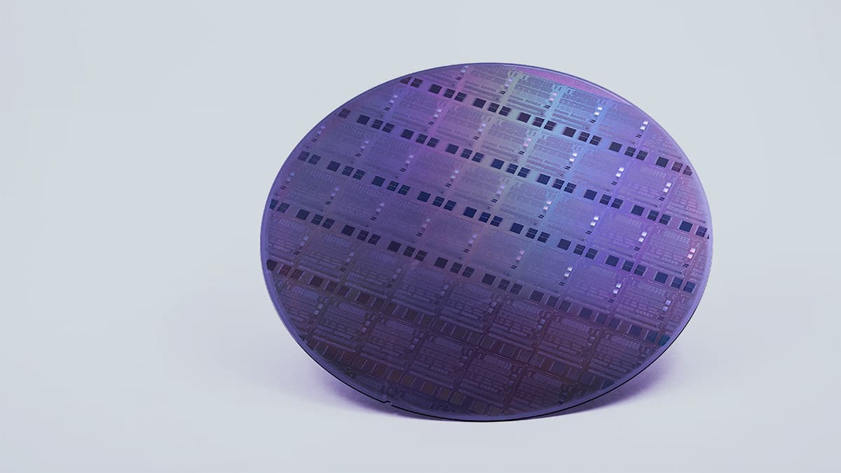 SiN-Photonics-wafer Purple silicon photonics wafer with patterned chip structures on a light background