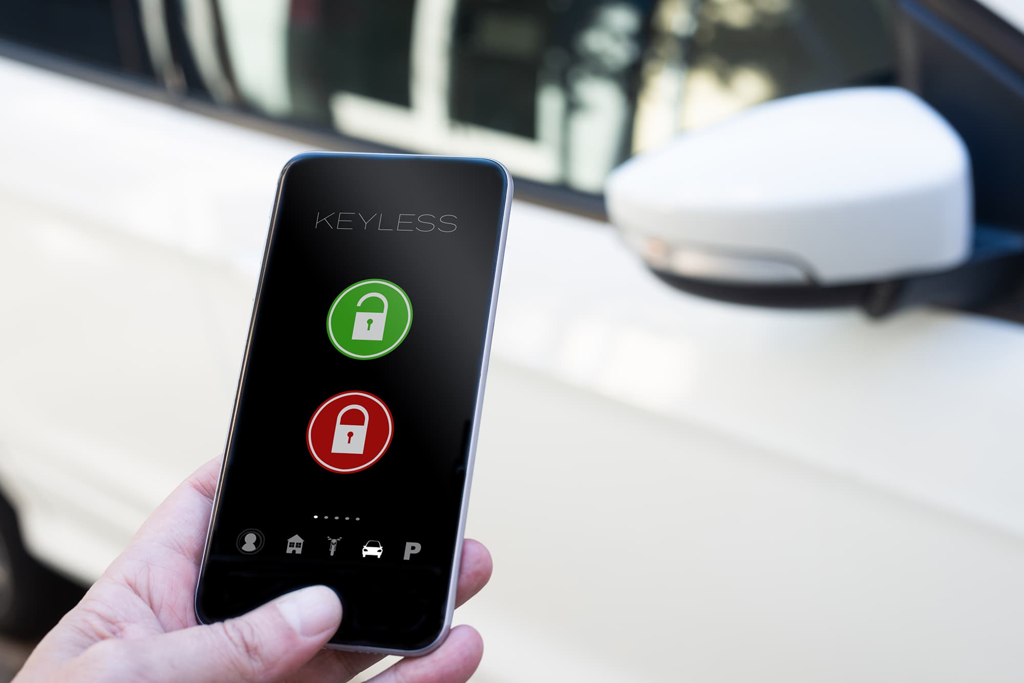 smart-locks Hand holding a smartphone with a keyless lock app beside a car door mirror