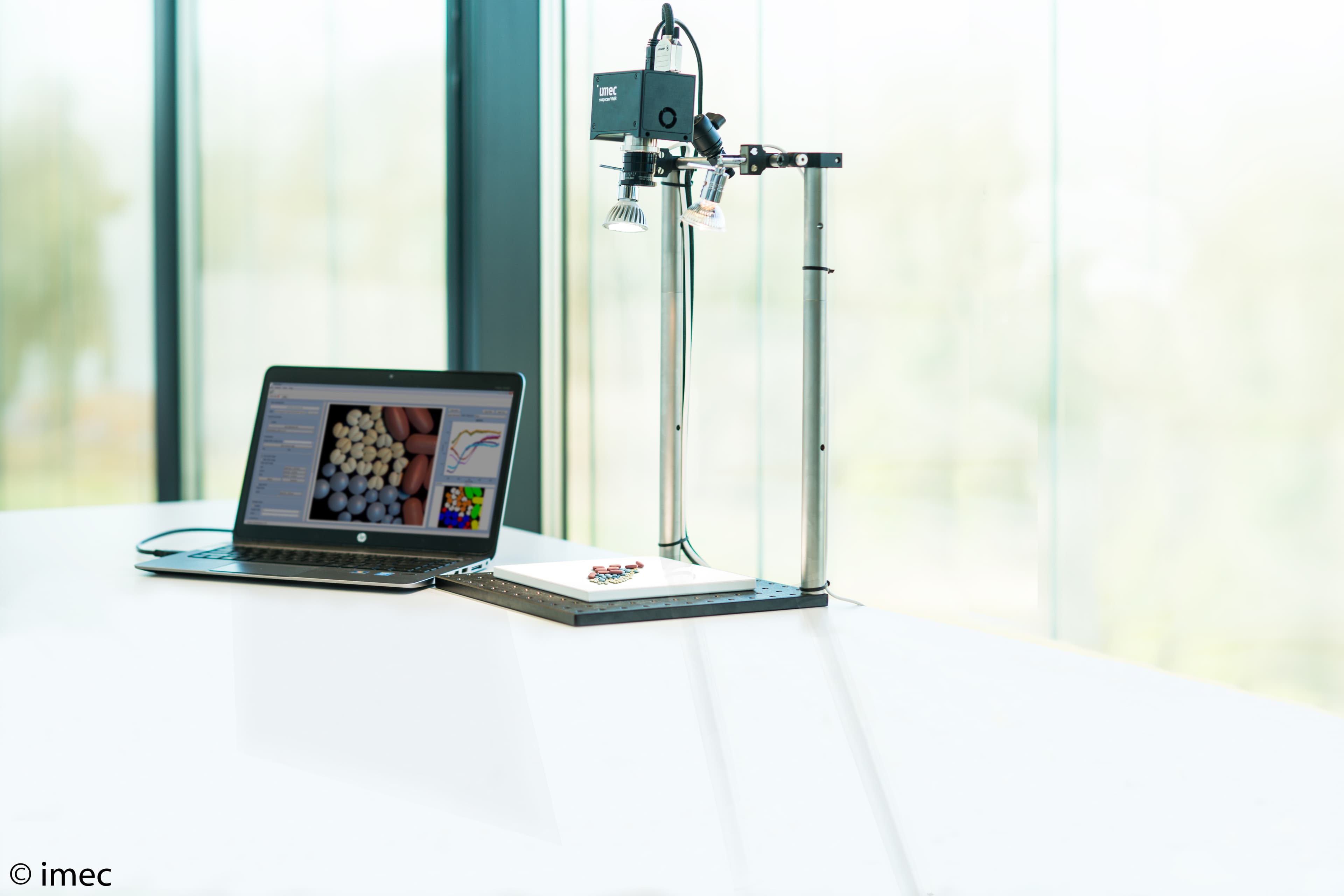 snapscan_0 Hyperspectral camera setup with a laptop analyzing samples on a lit platform