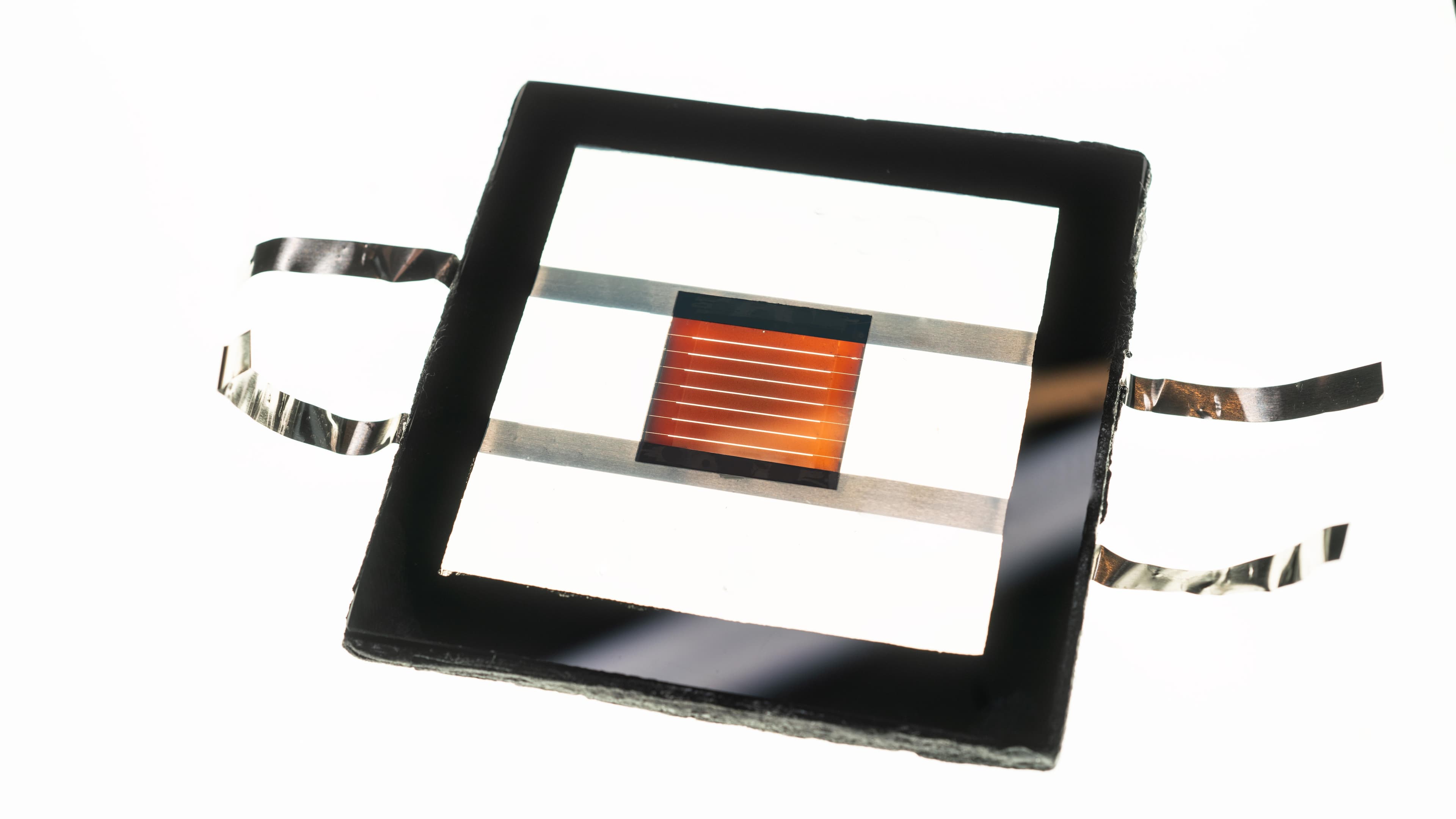 Solar-perovskite-mini-modules002 Perovskite solar mini module with orange striped cell in a black frame