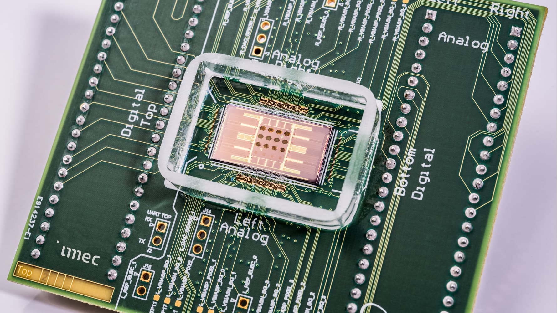 sparrow_1 imec neural probe chip mounted on a circuit board, with a central microchip under a clear frame