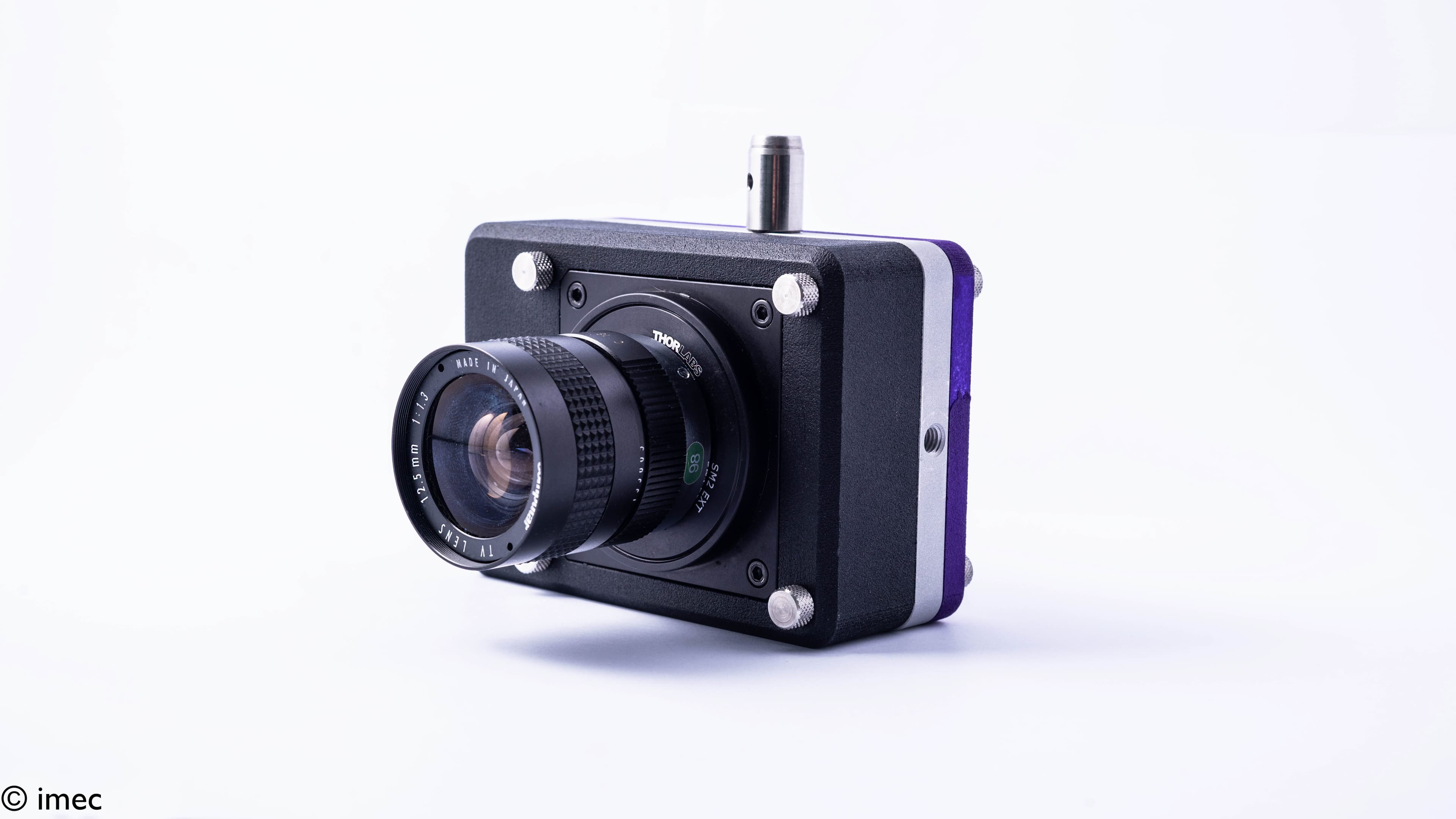 swir-image-sensor_1 Compact camera module with a large lens attached to a black sensor housing on a white background