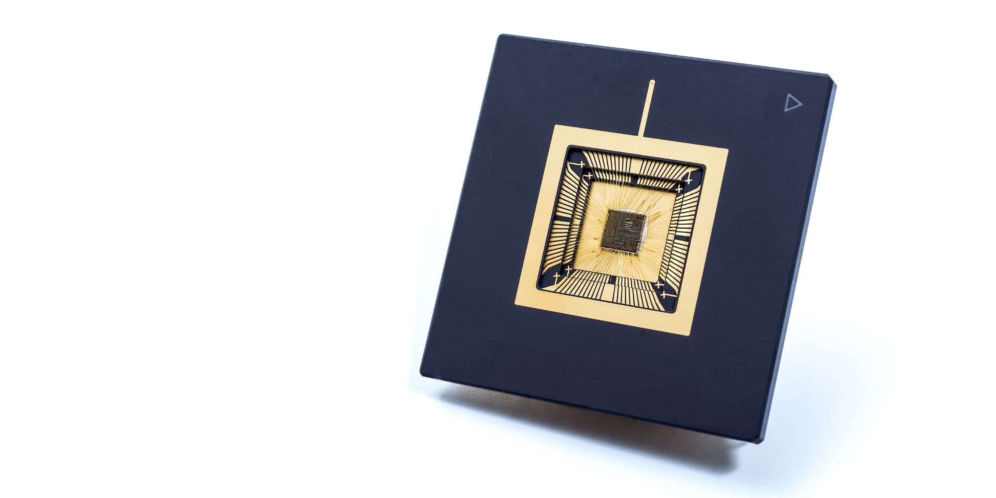 systems-on-chip-for-medical-sensor-devices_1 Packaged microchip with gold wire bonds on a dark substrate