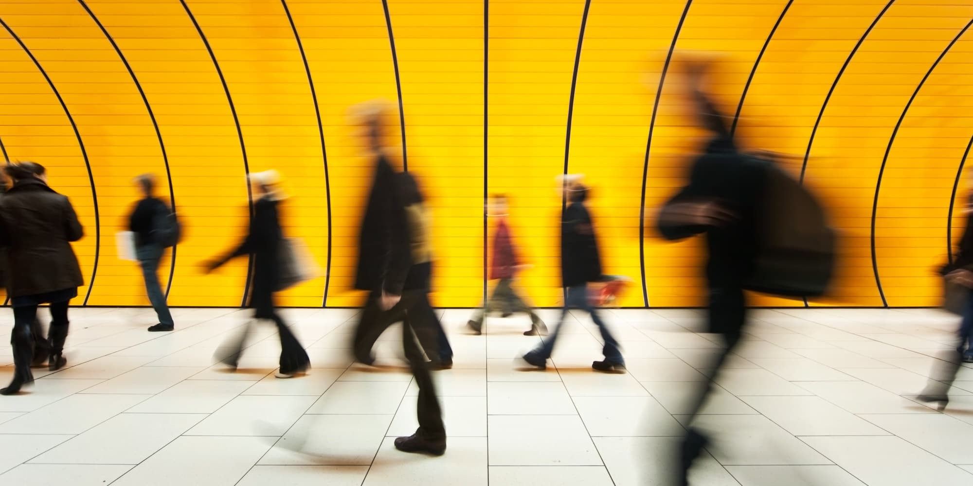 Ultra-small%2C-economical-and-cheap-radar-made-possible-thanks-to-chip-technology_1 Blurred pedestrians walking past a bright yellow curved wall in a transit corridor