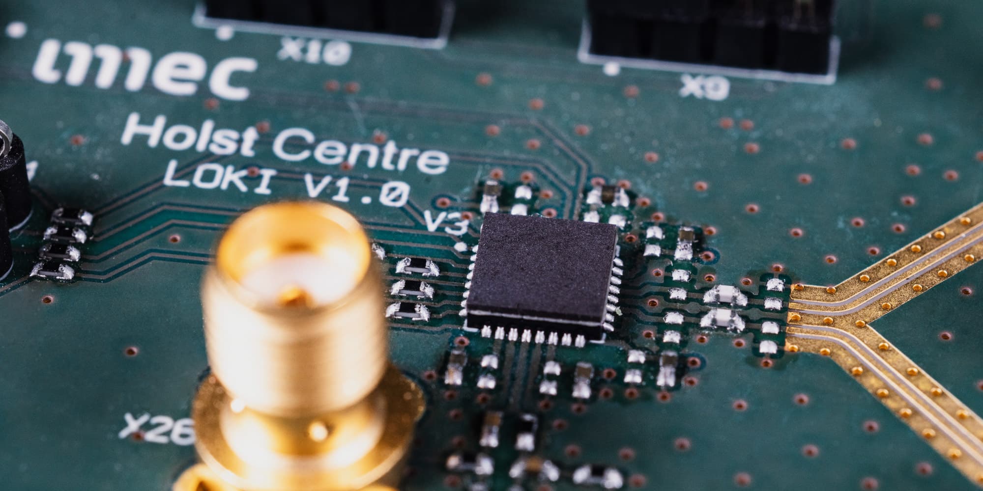 ultra-wide-band-technology Close-up of a circuit board with a chip and gold antenna traces for wireless connectivity