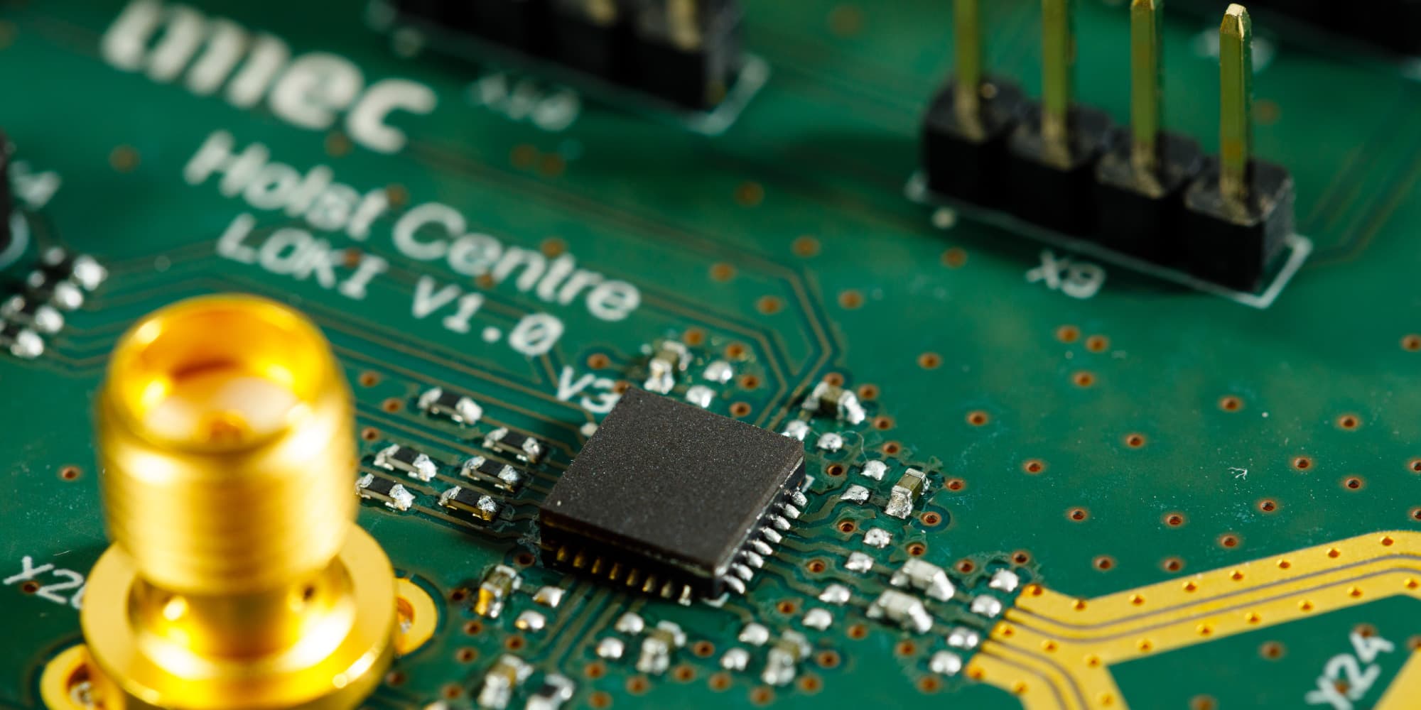 Ultra-Wideband-is-gaining-traction-accuracy-down-to-the-centimeter Close-up of a circuit board with a black chip and gold connector, labeled imec Holst Centre LoX1 V1.0