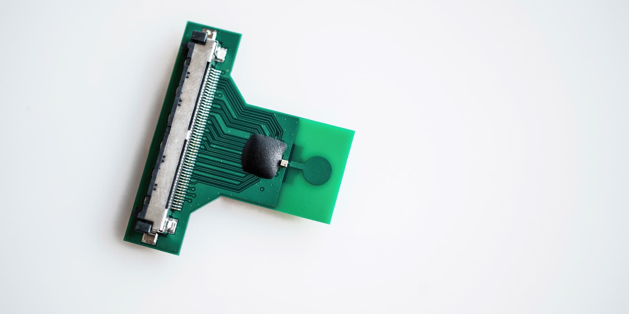 uwb Green circuit board with a connector and chip module on a white background