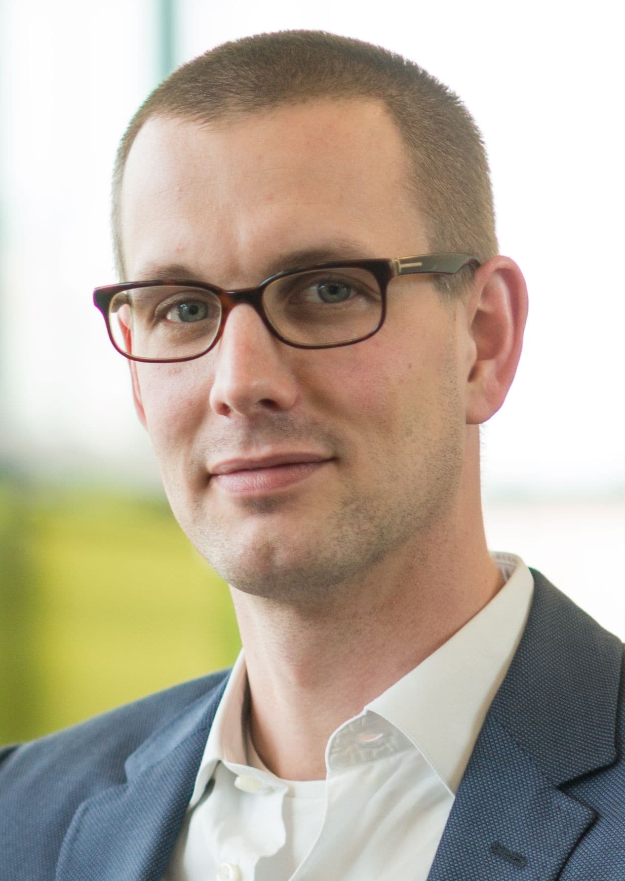wim_van_thillo_1 Portrait of Wim Van Thillo wearing glasses and a suit jacket