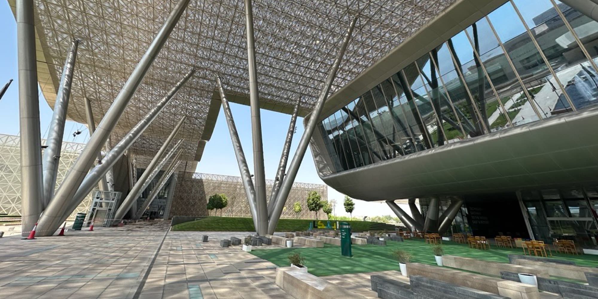imec-Qatar Modern imec Qatar office exterior with a large canopy, glass facade, and landscaped courtyard
