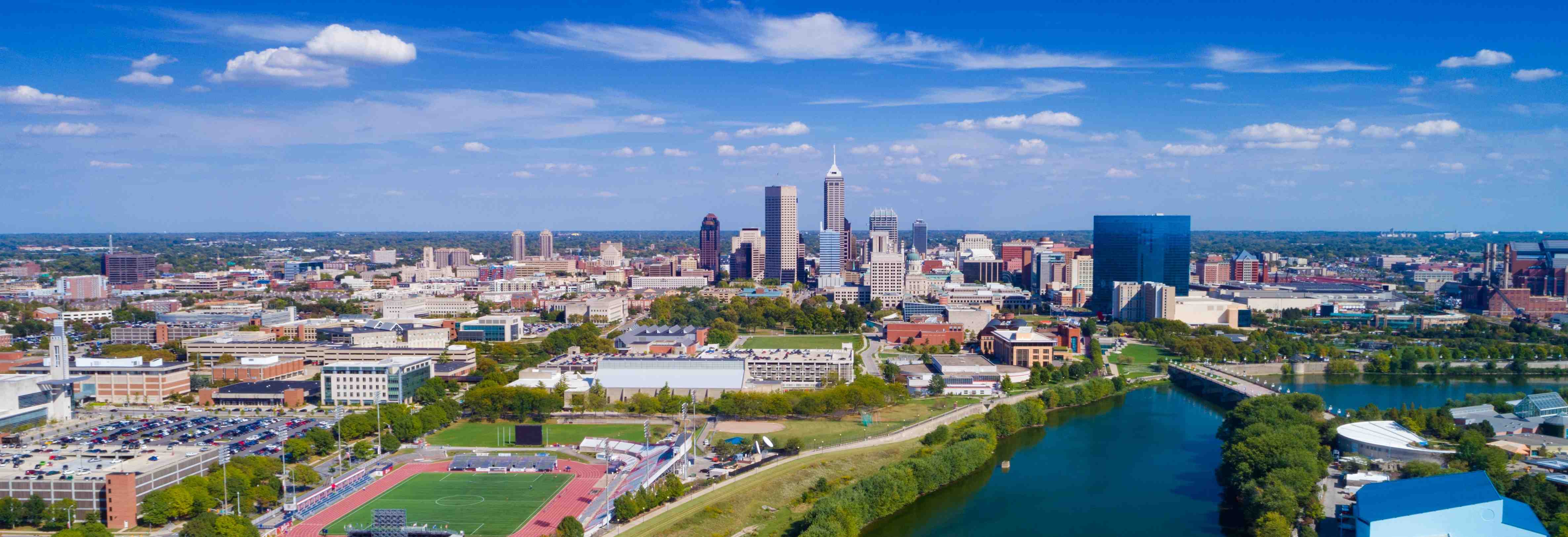 Imec%20Indiana Aerial view of downtown Indianapolis skyline beside the river and a university campus