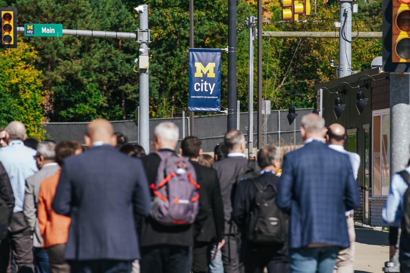 mstar%20automotive%20chiplet%20forum People walking toward the University of Michigan’s M City sign at an automotive forum.